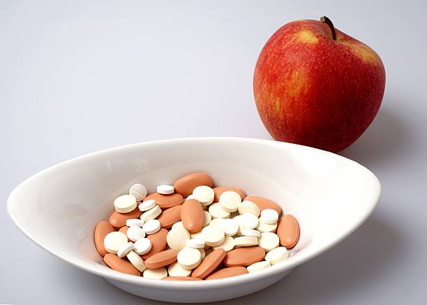 istock Medicine pills vs healthy apple 504603523