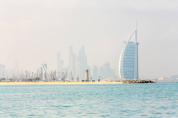 Dubai, United Arab Emirates - March 27, 2014:  External view of the Burj Al Arab in Dubai from the Jumeirah beach.  Burj Al Arab is one of the Dubai Landmark, and one of the world's famous and luxurious hotel in the world.