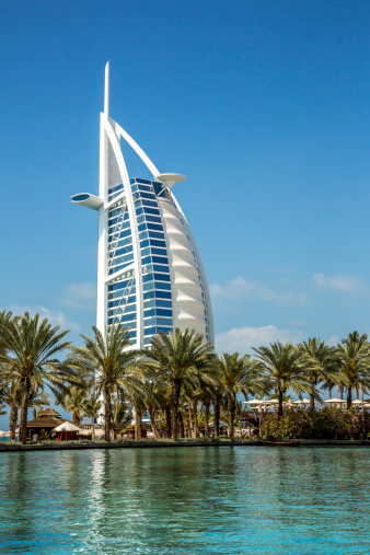 Dubai, United Arab Emirates - March 27, 2014:  External view of the Burj Al Arab in Dubai from the Jumeirah beach.  Burj Al Arab is one of the Dubai Landmark, and one of the world's famous and luxurious hotel in the world.