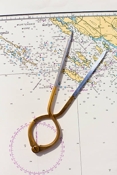 istock Pair of compasses for navigation on a sea map 504604573