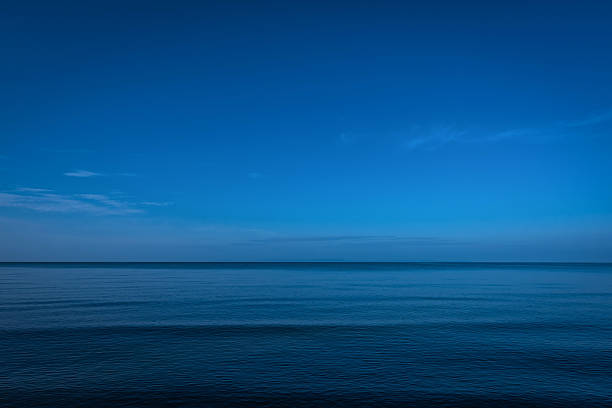 静かな夕暮れ時の海とダーク - 水平線 ストックフォトと画像