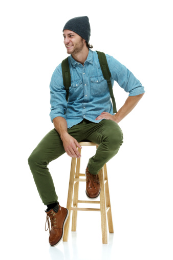 Smiling hipster sitting on stool & looking awayhttp://www.twodozendesign.info/i/1.png