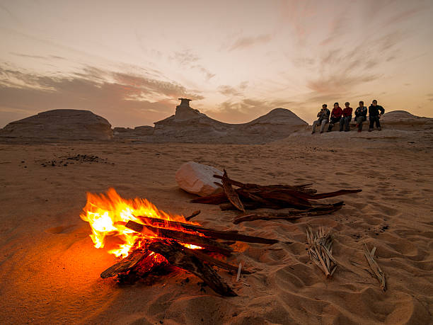 El Bawiti, Egypt - February 4, 2008: Campers and bonfire in the White Desert near Baharia Oasis, Egypt