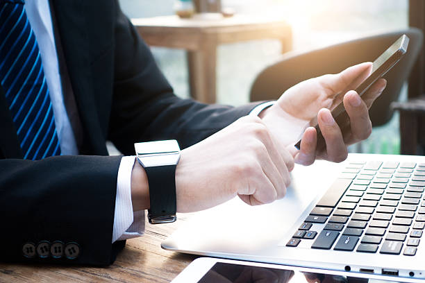 istock Businessman using smart watch and phone 504606022