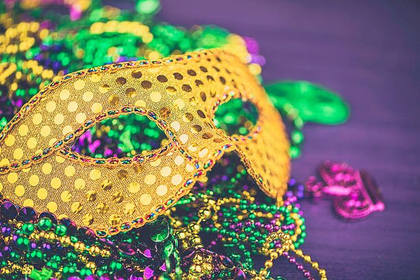 istock Mardi Gras background with novelty bead necklaces and masquerade mask 504606448