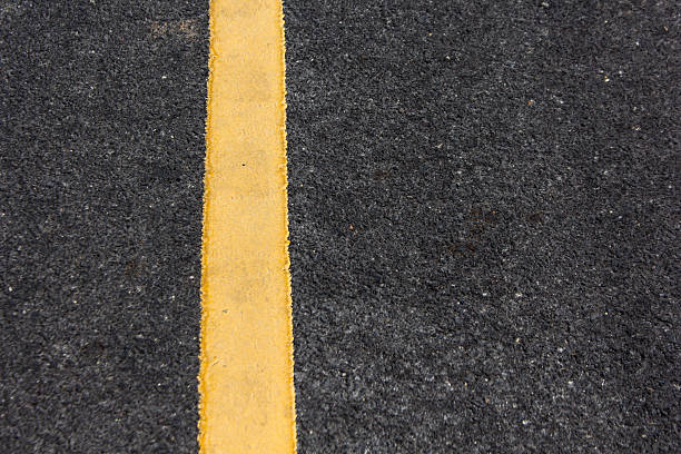istock Close up road divide yellow line 504606689