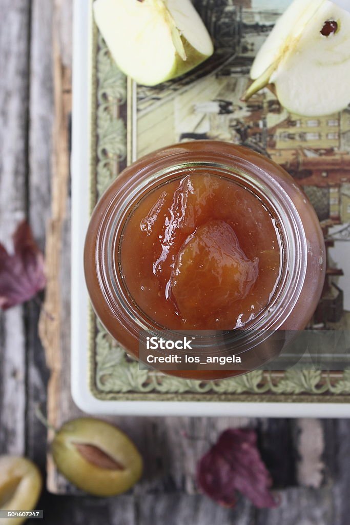 Homemade delicious plum jam with apples Homemade delicious plum jam with apples on a wooden background.Selective focus. Apple - Fruit Stock Photo