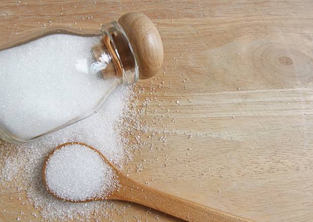 istock white sugar in wood spoon 504609766