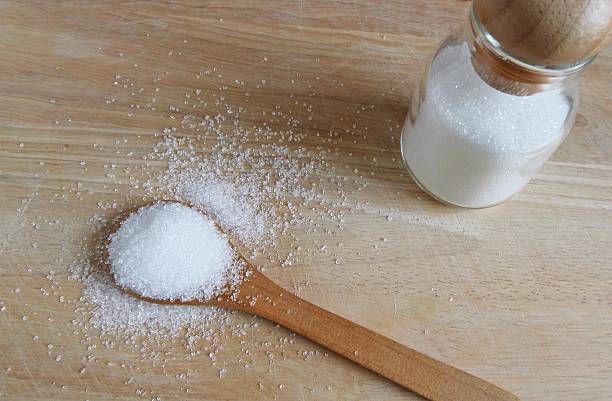 istock white sugar in wood spoon 504609952
