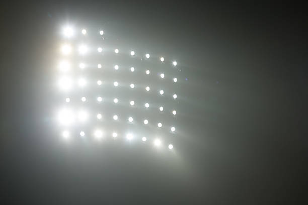 istock Bright white and yellow Stadium lights with fog 504610780