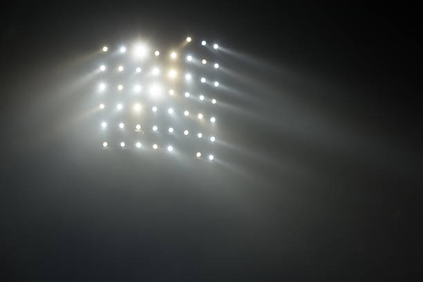 istock Bright white and yellow Stadium lights with fog 504610850