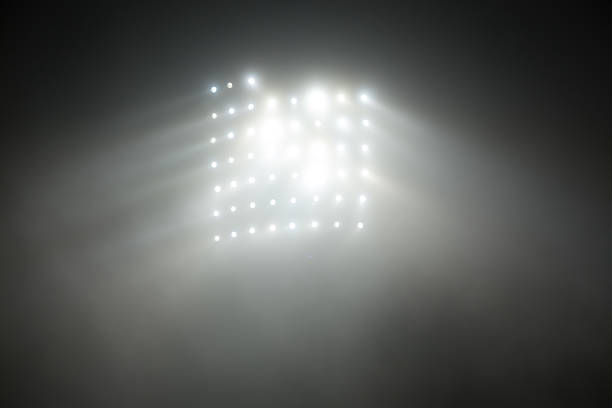 istock Bright white and yellow Stadium lights with fog 504611772