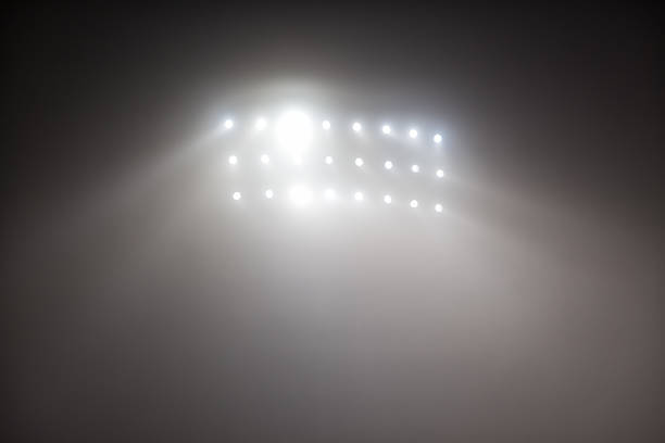 istock Bright white and yellow Stadium lights with fog 504611880