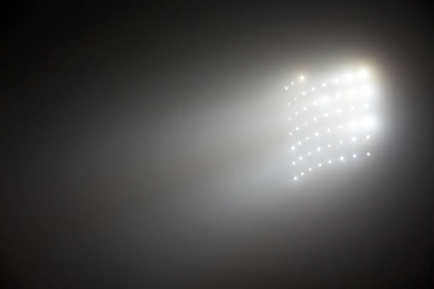 istock Bright white and yellow Stadium lights with fog 504612140