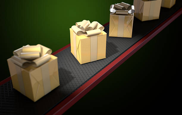 istock Golden Wrapped Gift Box On Conveyor 504613696