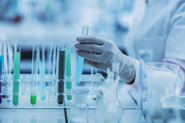 Unrecognizable person taking a test tube for an experiment.