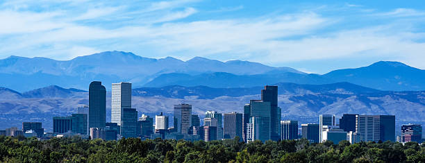 Denver Colorado Skyline Against the Rockies The Denver city skyline, downtown against the backdrop of the Rocky Mountains. colorado stock pictures, royalty-free photos & images