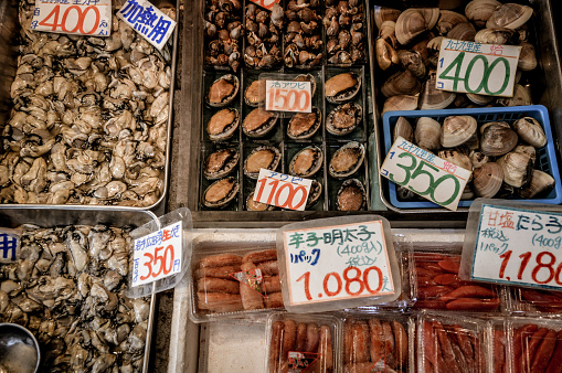 Tokyo, Japan - November 21, 2015: Fish products on display at Tsukiji Fish Market in Tokyo. With an annually estimated turnover of 5.5 billion dollars and more than 60.000 workers ,this is the biggest wholesale and seafood market in the world. With more than 2000 tons of seafood handled daily it is said that any eatable seafood can be found here. 