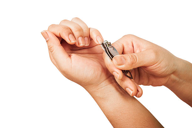 istock beautiful woman cut fingernail with herself. 504615076