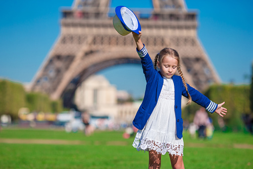 Adorable little girl in Paris background the Eiffel tower in France