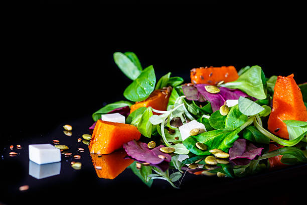 istock Fresh vegetables salad  on a black background, le 504617326