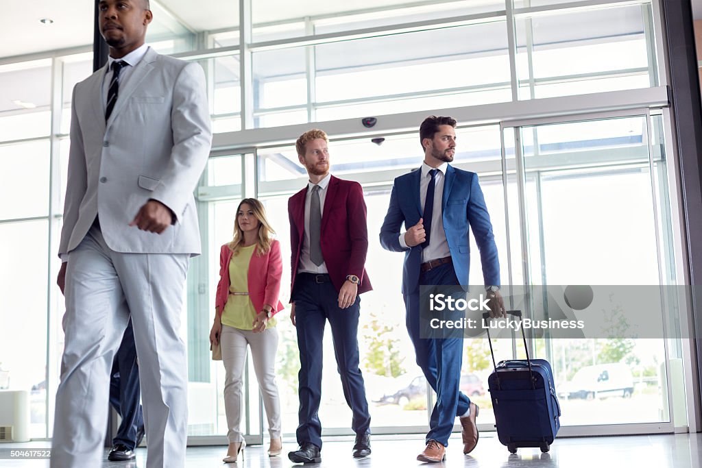 Business people at airport Business people walking in airport Airport Stock Photo