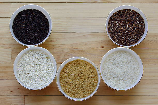 istock Rice on dark wooden table 504636032