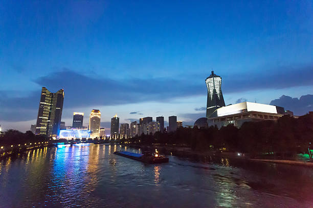 istock waterfront city building in blue sky at night 504636576