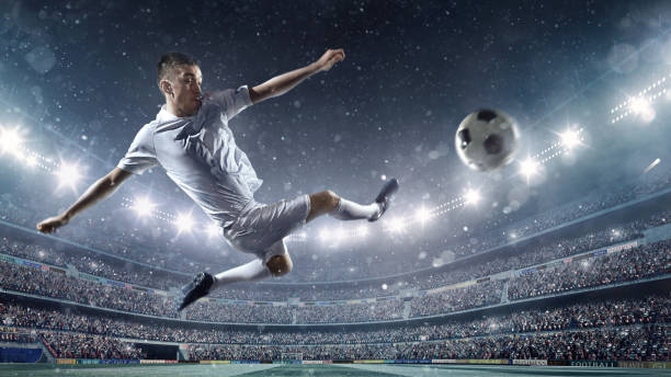 istock Soccer player kicking ball in stadium 504638952