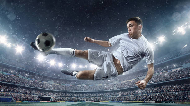 istock Soccer player kicking ball in stadium 504639240