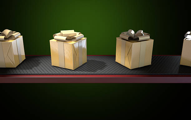 istock Golden Wrapped Gift Box On Conveyor 504640602