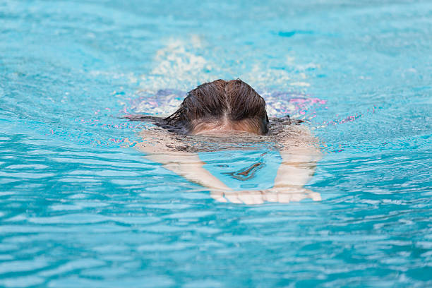 istock Woman while swimming, diving head just under the water 504644544