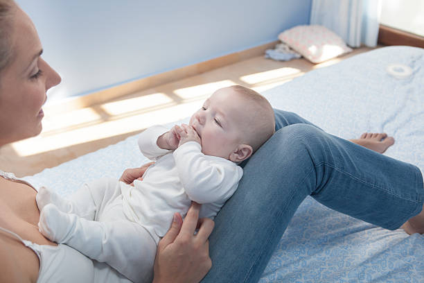istock young mother playing with her baby after feeding breast 504646340