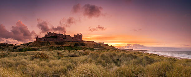 bamburgh castle panorama - bamburgh stock-fotos und bilder