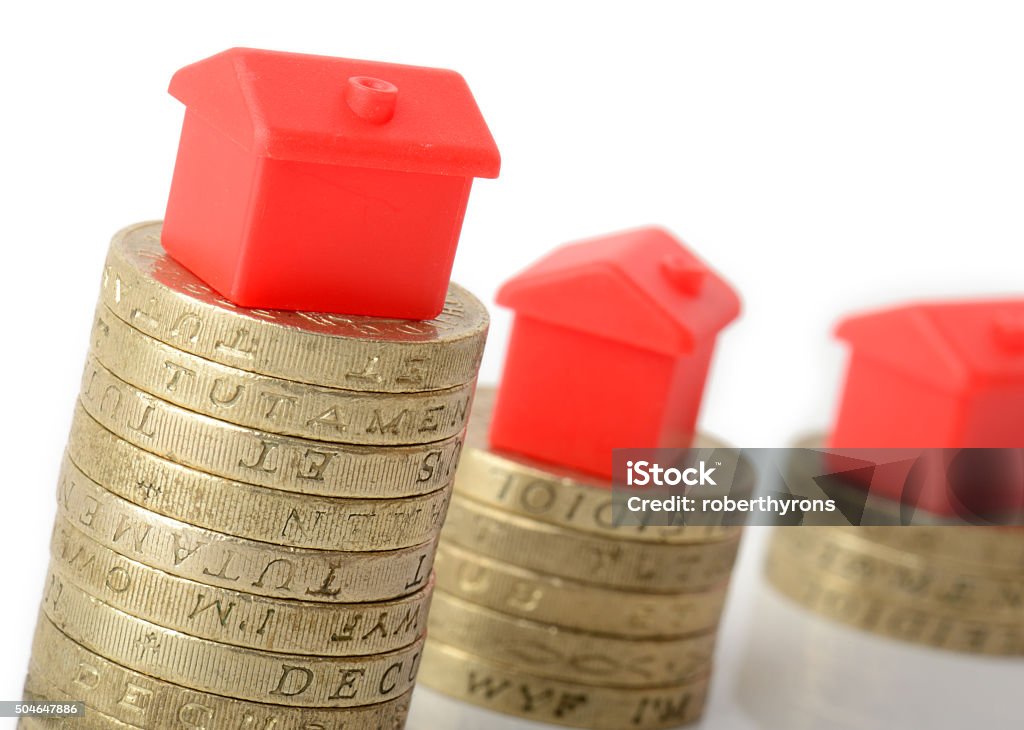 Mortgage concept by money house from the coins Mortgage concept small houses on stacks of coins Architecture Stock Photo