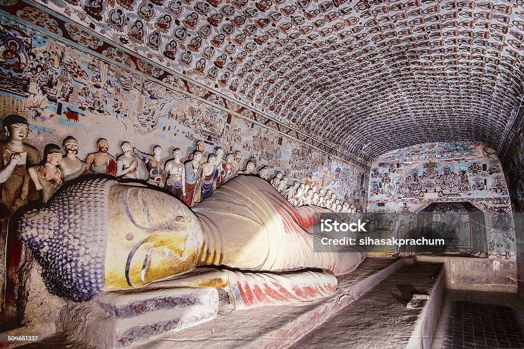 mogao caves reclining buddha gold statue at mogao caves in the desert near dunhuang,china.A UNESCO world heritage site. Mogao Caves Stock Photo