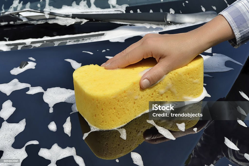 Car Care - Washing a Car by Hand Washing a car with a sponge by hand. Adult Stock Photo