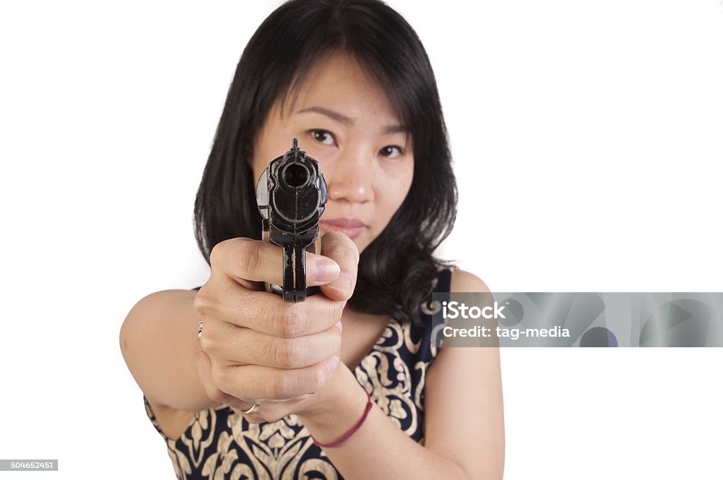 Pointing a gun Middle Aged Vietnamese Woman pointing a gun directly at the camera. 30-39 Years Stock Photo