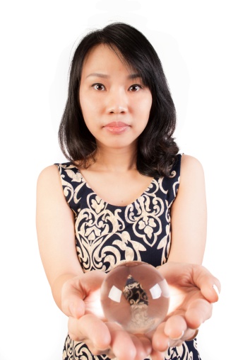 Middle aged Vietnamese woman holding a crystal ball.