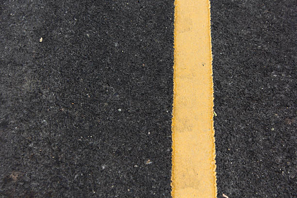 istock Close up road divide yellow line 504652969