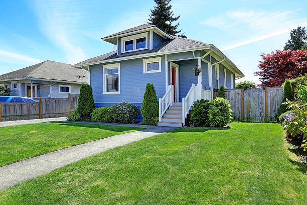 istock House exterior in light blue. View of front yard 504653937