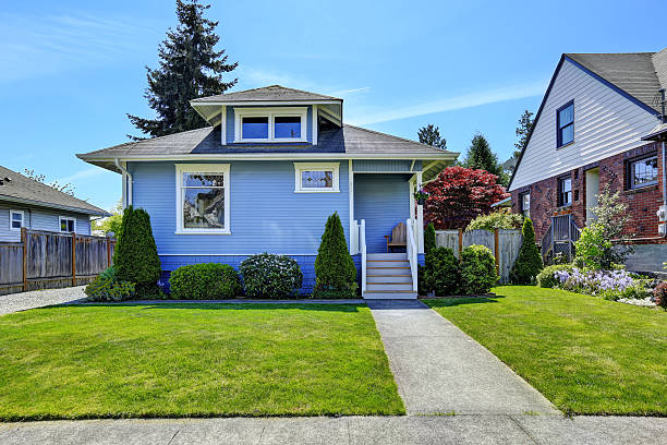 istock House exterior in light blue. View of front yard 504653943