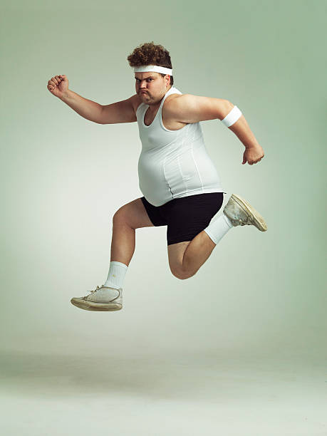 I feel in shape already Overweight man leaping in the air with his sense of achievement sweat band stock pictures, royalty-free photos & images