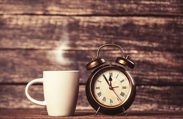 istock Tea or coffee cup and alarm clock 504655599