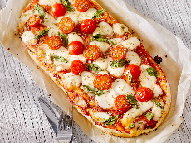 Margherita Flat Bread Pizza Margherita Pizza with Fresh Mozzarella,Tomatoes and Basil on Thin Flat Bread - Photographed on a Hasselblad H3D11-39 megapixel Camera System flatbread photos stock pictures, royalty-free photos & images
