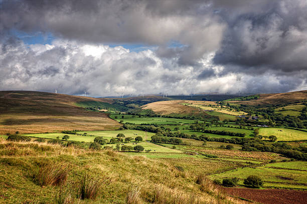 istock Welsh farmland with wind turbines on horizon 504656459