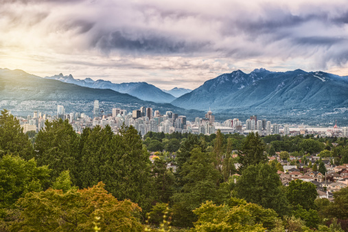 Vancouver Downtown at Autumn Time Beautiful view of Vancouver skyline with Stanley Park   modern buildings and s sea wall walking path on the background of cloudy sky  BC Canada