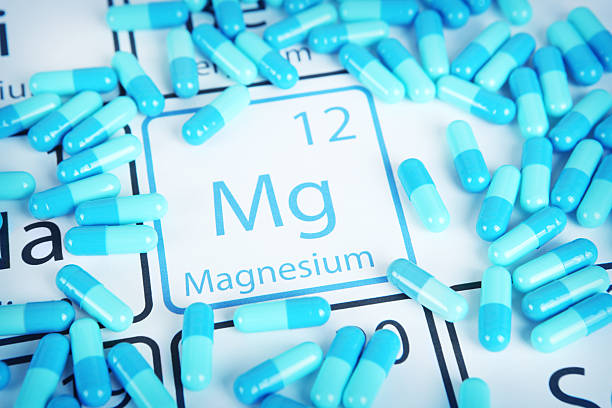 Magnesium - Mineral Supplement on Periodic Table Magnesium with capsules or pills on the periodic table (Periodic table made by me)  Stock image representing mineral supplementation. periodic table photos stock pictures, royalty-free photos & images