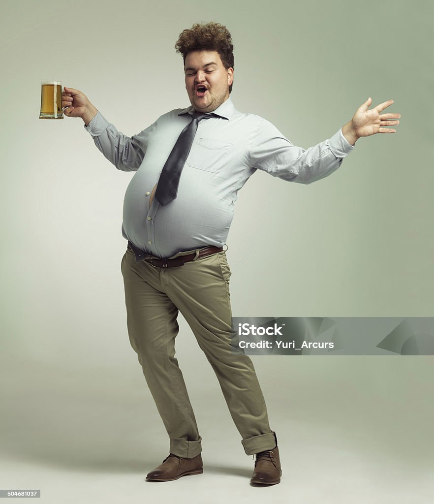 I'm a party animal! Shot of an overweight man celebrating while holding a pint of beer Drunk Stock Photo