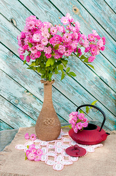 still life bouquet with roses and tea pot